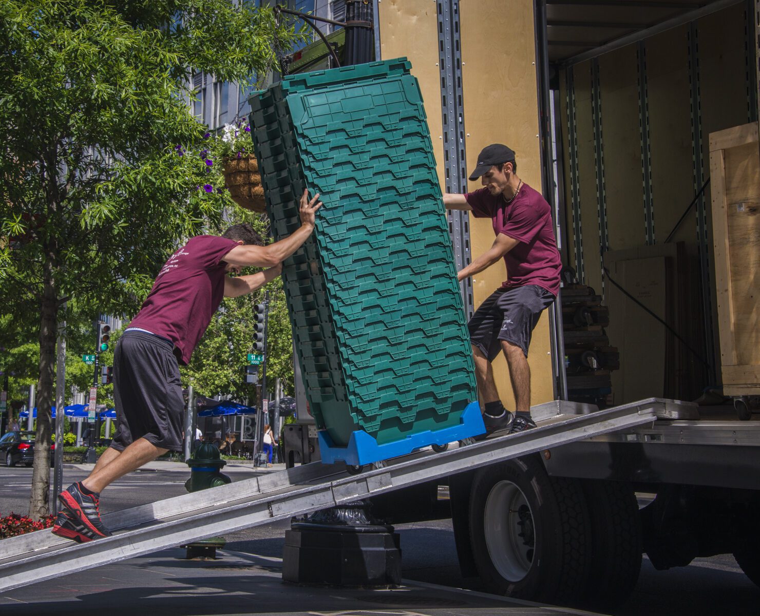 2 Olympia moving staffs loading a container to the truck