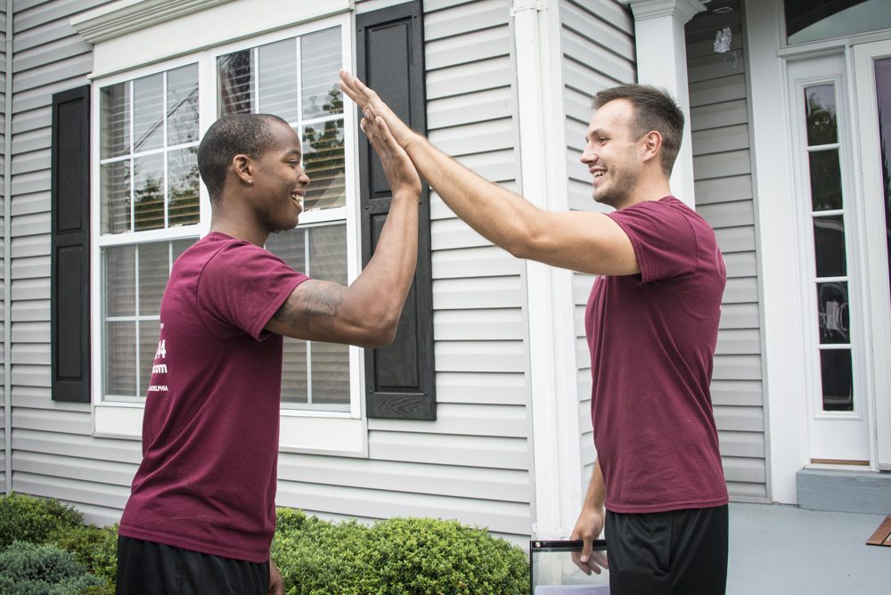 Olympia Moving staffs doing high five