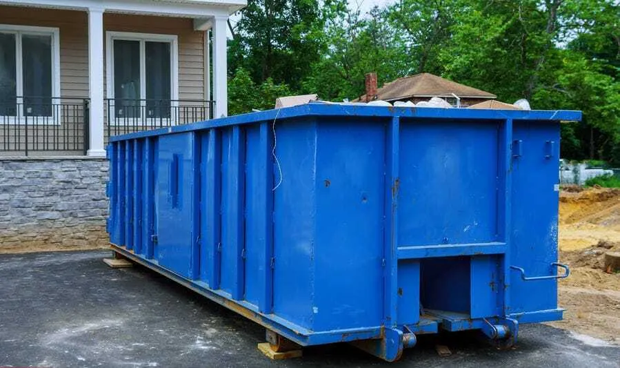 blue-dumpster-in-new-home-driveway