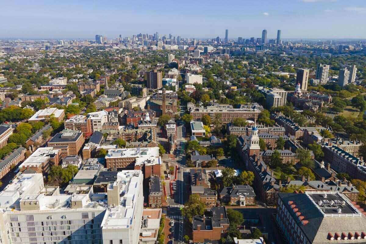 aerial view of historic city center of Cambridge on Mt Auburn Street with Boston modern city skyline at the background, Cambridge, Massachusetts MA