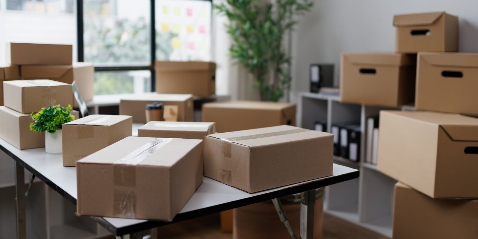 cardboard shipping boxes and moving cartons filling an office or home space
