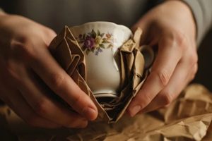 careful hands wrapping delicate antique vase in protective brown paper