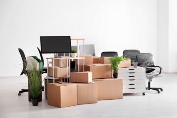 carton boxes with stuff in empty room office move concept