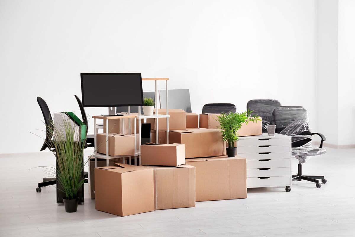 carton boxes with stuff in empty room office move concept