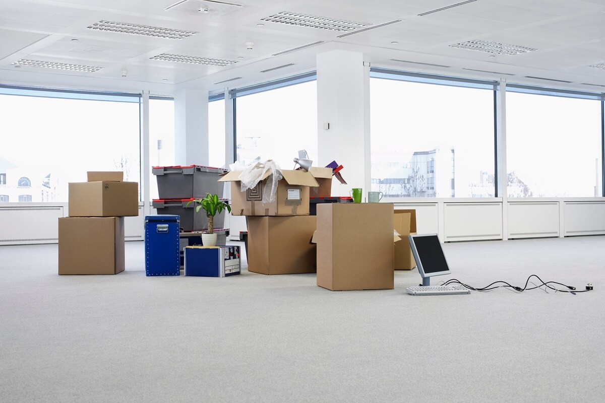 cartons and equipment on floor of empty office space