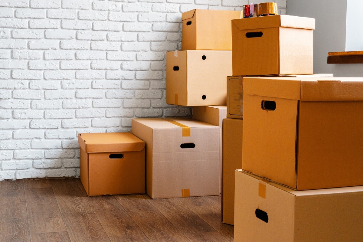 close up of moving carton boxes in an empty room