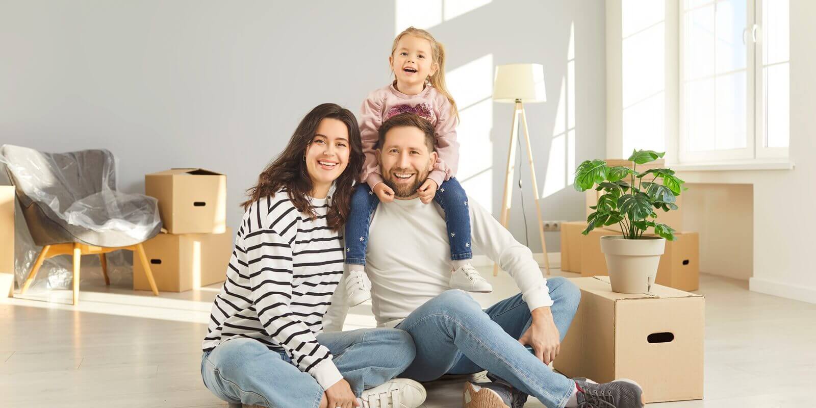 family enjoys moving new apartment, happy mother, father, cute child near cardboards