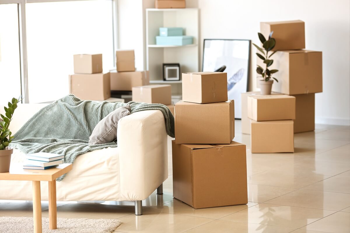 furniture, belongings and moving boxes in room