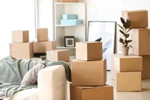 furniture, belongings and moving boxes in room