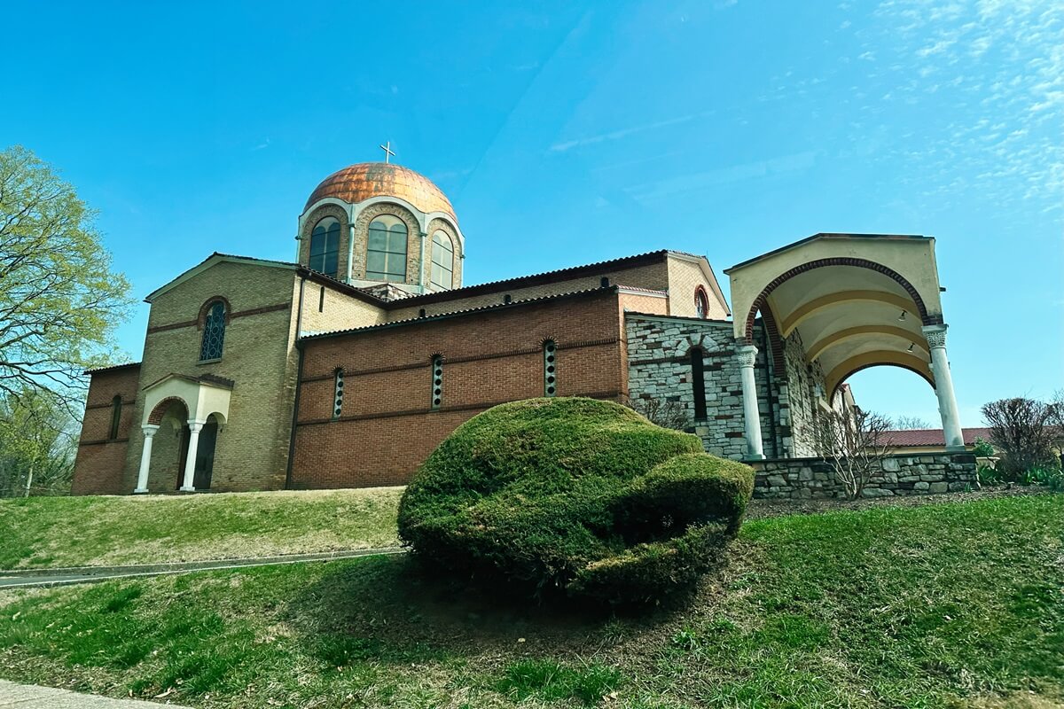 historic annunciation greek orthodox church with copper dome under blue sky in Elkins Park PA