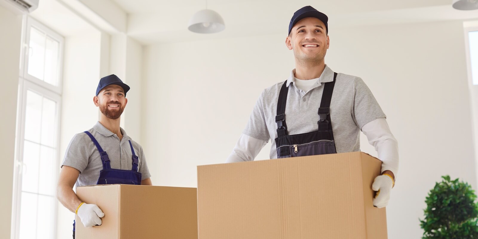 men carrying cardboard boxes, movers service unloading and removing things for moving company