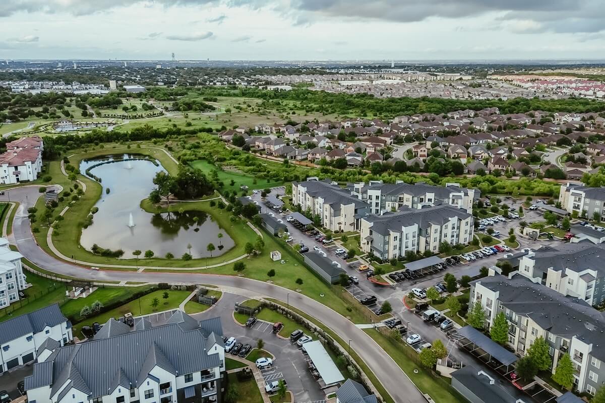 mixed-use development area with pond water fountain Pflugerville Texas