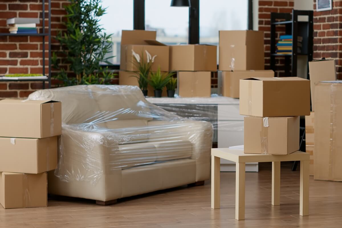 no people in empty living room apartment with carton boxes on stack