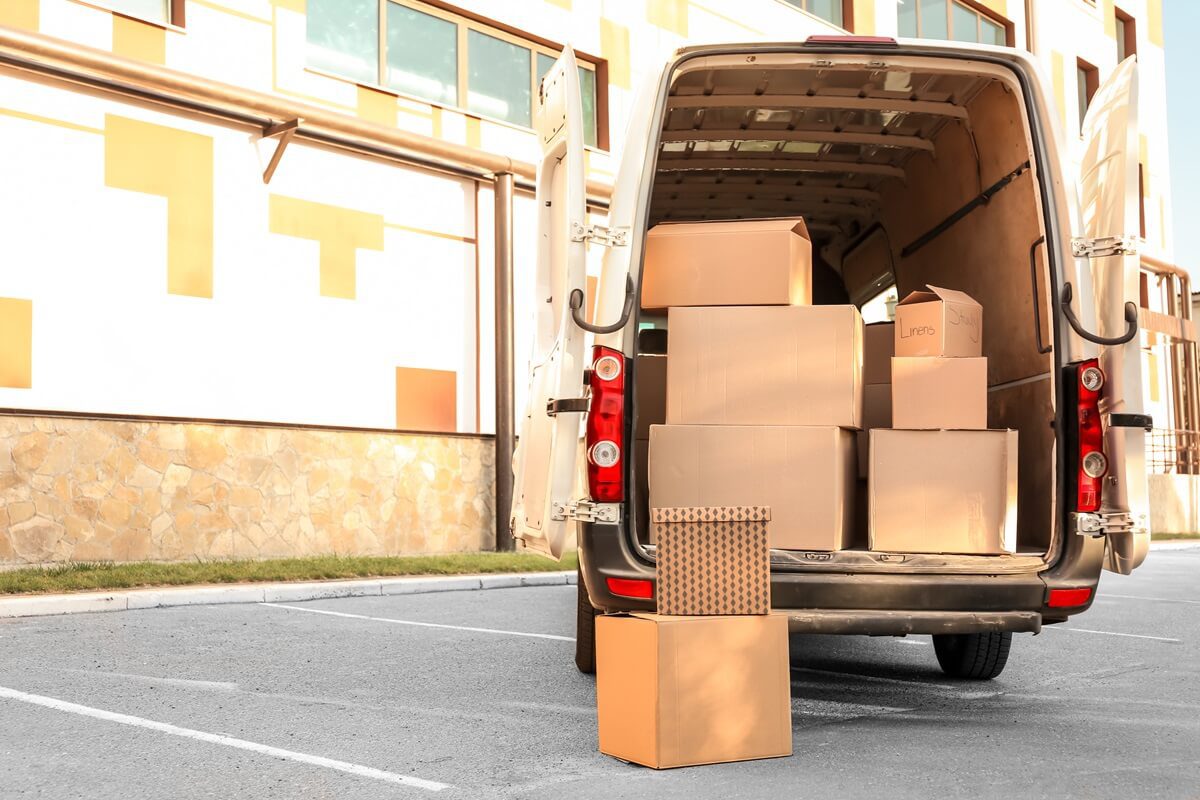 open car trunk with moving boxes outdoors