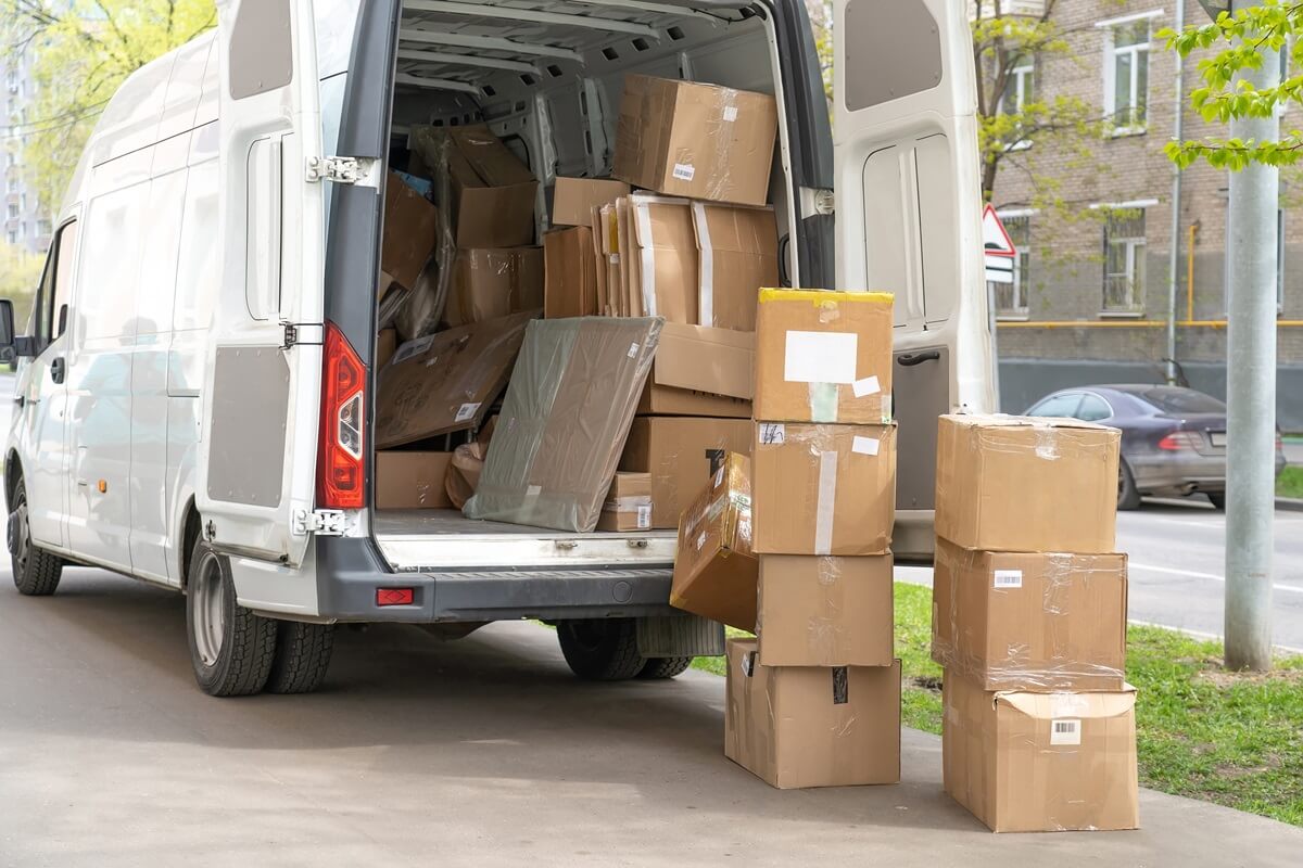 open lorry car trunk with moving cardboard packages outdoors