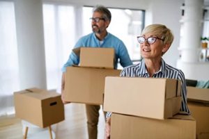 portrait of happy senior couple in love moving in new home