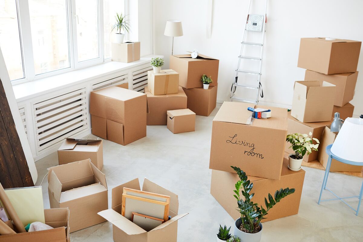 wide angle background image of stacked cardboard boxes in empty room
